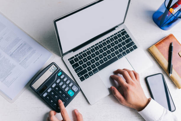 Asian Businessmen use a calculator to calculate tax and income